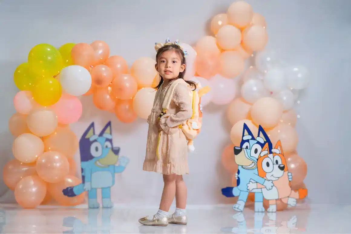 Balloon party setup with Bluey character cutouts
